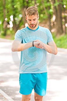 Combining technology with style. Fit man tracking his performance with sports watch technology. Handsome athlete using