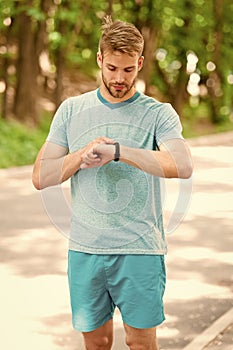 Combining technology with style. Fit man tracking his performance with sports watch technology. Handsome athlete using