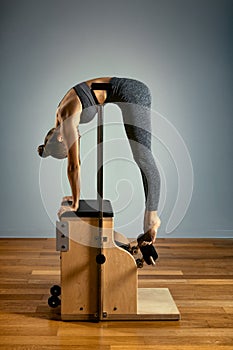 Combo wunda pilates chair woman instructor fitness yoga gym exercise. Copy space. sports banner photo