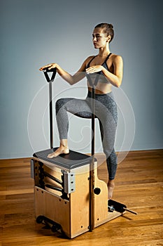 Combo wunda pilates chair woman instructor fitness yoga gym exercise. Copy space. sports banner