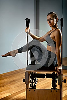 Combo wunda pilates reformer chair woman instructor close-up. Fitness Yoga Gym Exercise. Copy space. sports banner