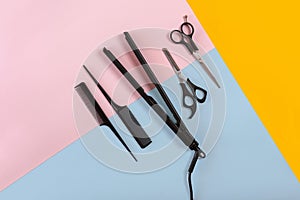 Combs and hairdresser tools on color background top view