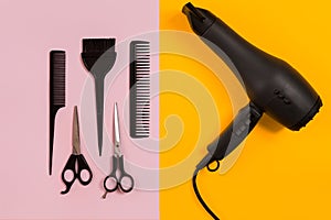 Combs and hairdresser tools on color background top view