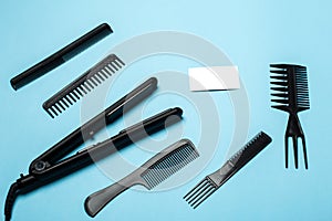 Combs and hairdresser tools on white background top view