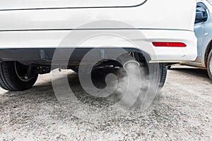 Combustion fumes coming out of car exhaust pipe, air pollution concept