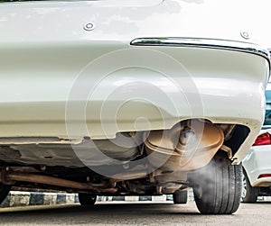 Combustion fumes coming out of car exhaust pipe, air pollution concept