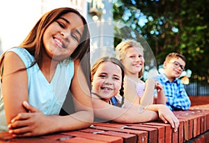 Come hangout with the cool kids. Portrait of a group of young children playing together outside.