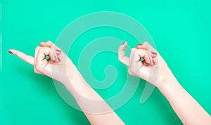 The Come Hither Hand Sign. Woman hand beckoning on isolated turquoise green color background. Female hand beckoning photo