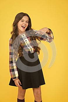Come with me. Hey you. Manners of hothead. Girl long hair cool pointing forward. Child pointing camera yellow background