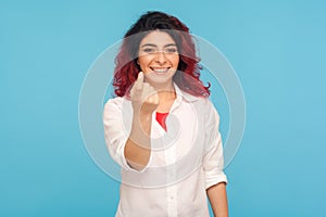 Come to me! Charming positive hipster woman with fancy red hair smiling friendly and showing beckoning gesture