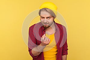 Come to me! Playful hipster bearded guy in beanie hat and checkered shirt doing beckoning gesture, calling