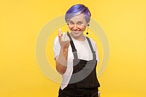Come to me! Portrait of friendly cheerful hipster girl showing beckoning gesture. indoor studio shot