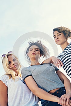 We come with a whole lotta attitude. a group of friends spending the day together on a sunny day. photo