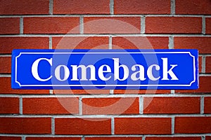 Comeback street sign on brick wall