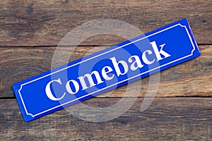 Comeback street sign on wooden background