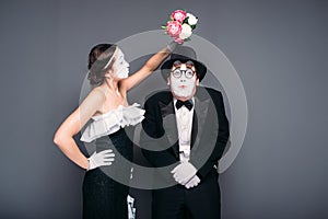 Comedy actor and actress poses with flower bouquet