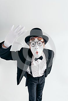 Comedy mime artist in glasses and makeup mask