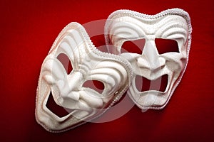 Comedy and Tragedy theatrical mask isolated on a red background