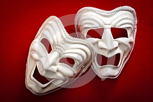 Comedy and Tragedy theatrical mask isolated on a red background photo