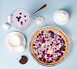 Comfort food. Blueberry open pie served with milk, smoothie, mar