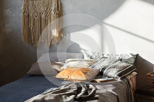 Comfort loft bedroom interior with bed in gray color. Concrete wall on background