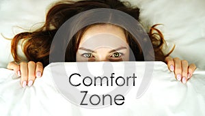 Comfort Zone concept. The face of a woman under a blanket. The desire to hide from fear while remaining inactive