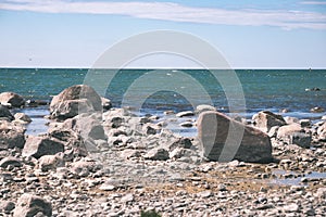 comfortable beach of the baltic sea with rocks and green vegetat