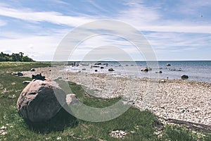 comfortable beach of the baltic sea with rocks and green vegetat