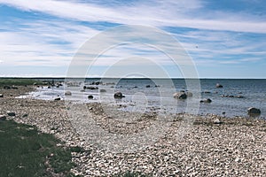 comfortable beach of the baltic sea with rocks and green vegetat