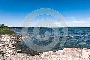 comfortable beach of the baltic sea with rocks and green vegetat