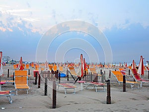 Comfortable beach with sun beds and orange umbrellas