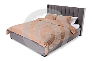 Comfortable bed with beige linens on white background