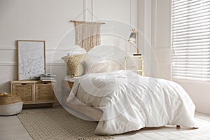 Comfortable bed with clean white linens