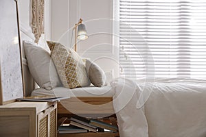 Comfortable bed with clean white linens indoors