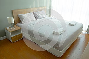 Comfortable bed in modern bedroom