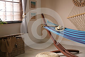 Comfortable blue hammock in room. Interior design