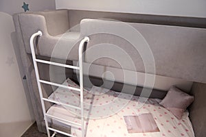 Comfortable bunk bed family bedroom concept idea. Model of designed children bedchamber displayed for sale in furniture showroom.