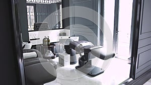 Comfortable chair and couch for washing hair and head massage in spa salon. Interior modern hairdressing salon with