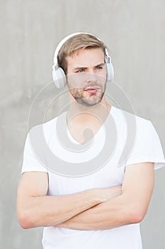 Comfortable ergonomic design. Modern guy wear headphones grey background. Handsome man listen to modern music. Modern