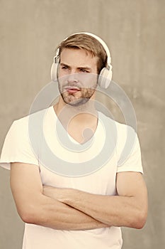 Comfortable ergonomic design. Modern guy wear headphones grey background. Handsome man listen to modern music. Modern