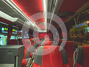 Comfortable, expensive bus with soft, red velor seats. expensive interior of the bus with many places for tourists. travel by land