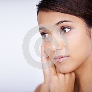 Comfortable in my own skin. Close up shot of beautiful young woman touching her face.