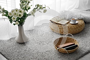 Comfortable place for rest with cup of tea and books near window