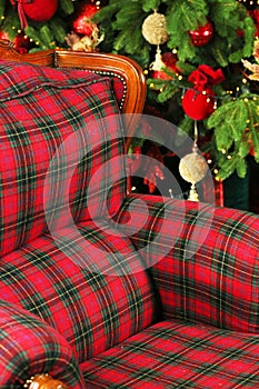 A comfortable red chair. Loft style. Christmas miracles. New Year`s interior. Cristmas