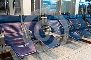 Comfortable seats with foot rest in the waiting area at the airport