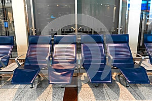 Comfortable seats with foot rest in the waiting area at the airport