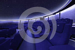 Comfortable seats in the planetarium with stars projection