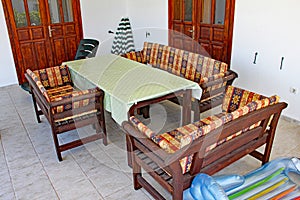 A comfortable set of chairs and settees around a table in a holiday apartment photo