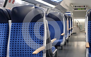 comfortable soft blue seats with headrests in half-empty train car in Germany, concept of long-distance travel, ticket for