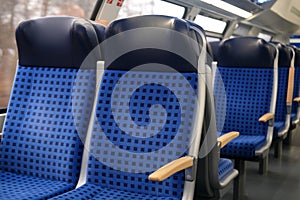 Comfortable soft blue seats with headrests in a train car in Germany